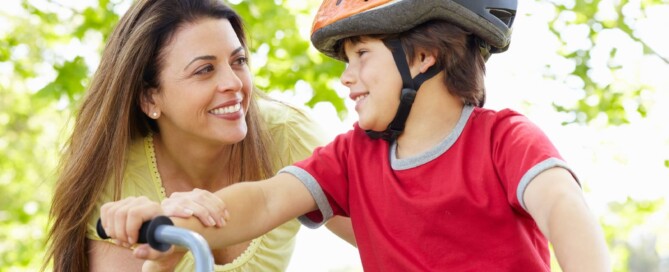 Mother teaching her child to ride a bike