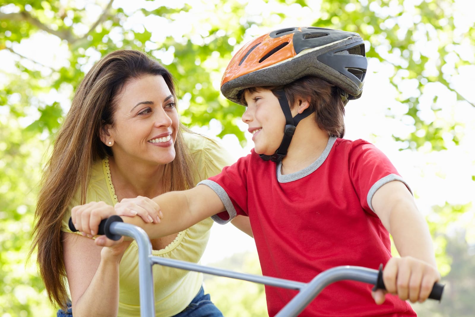 Mother teaching her child to ride a bike