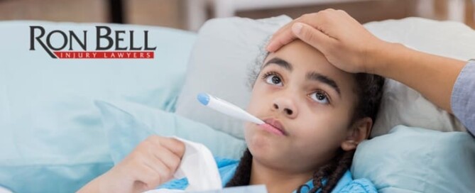 Concerned mother checks her daughter's temperature