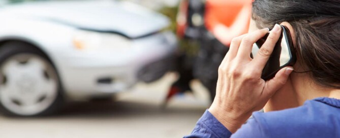 Woman on the phone after a car accident