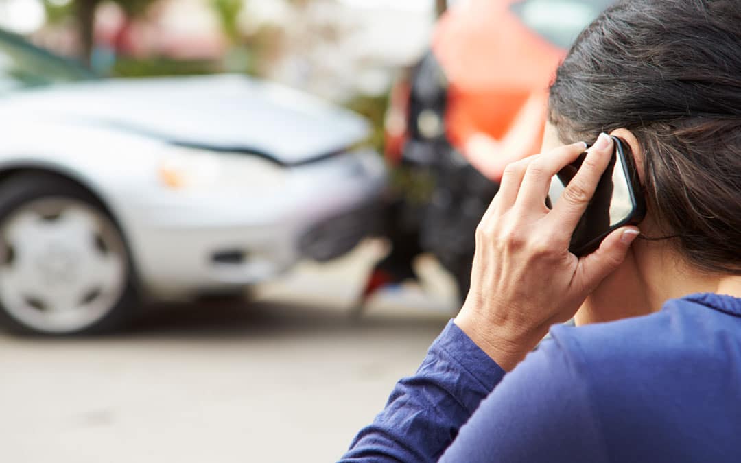 Woman on the phone after a car accident