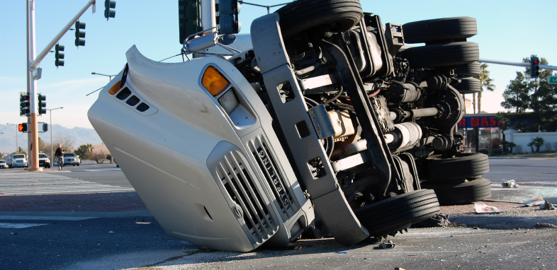 large truck tipped over in road intersection