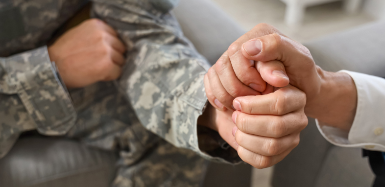 veteran holding hands with someone close up